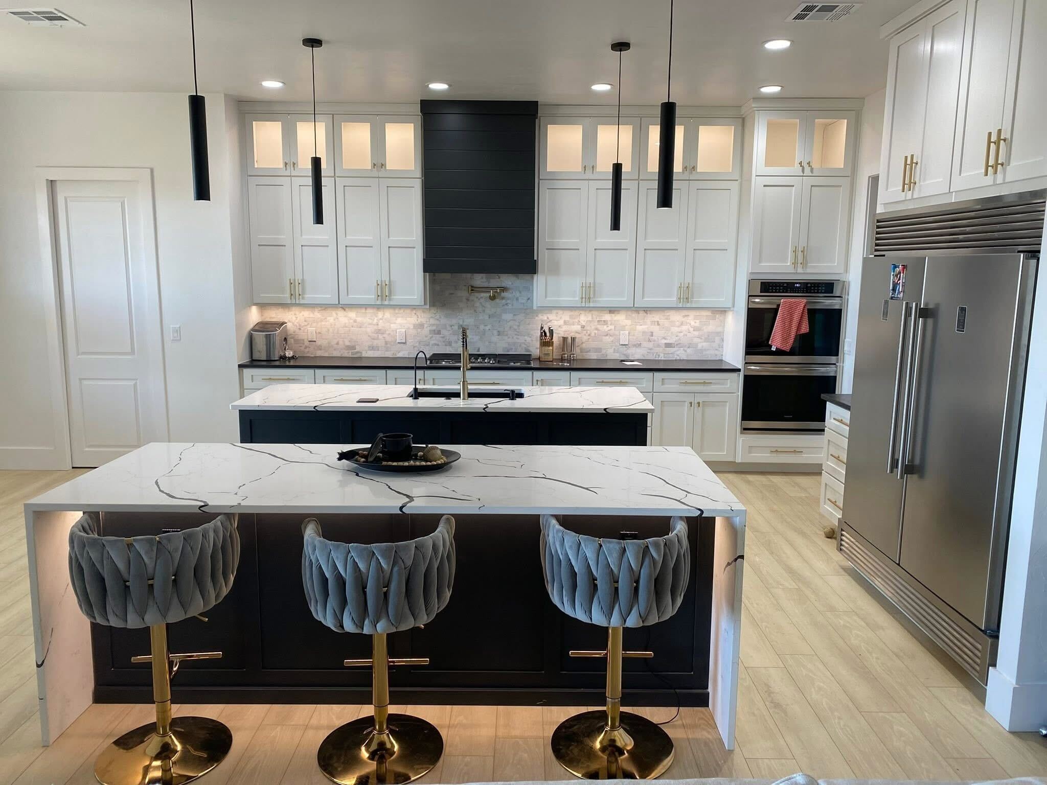 Modern white shaker kitchen with dark island and bar seating