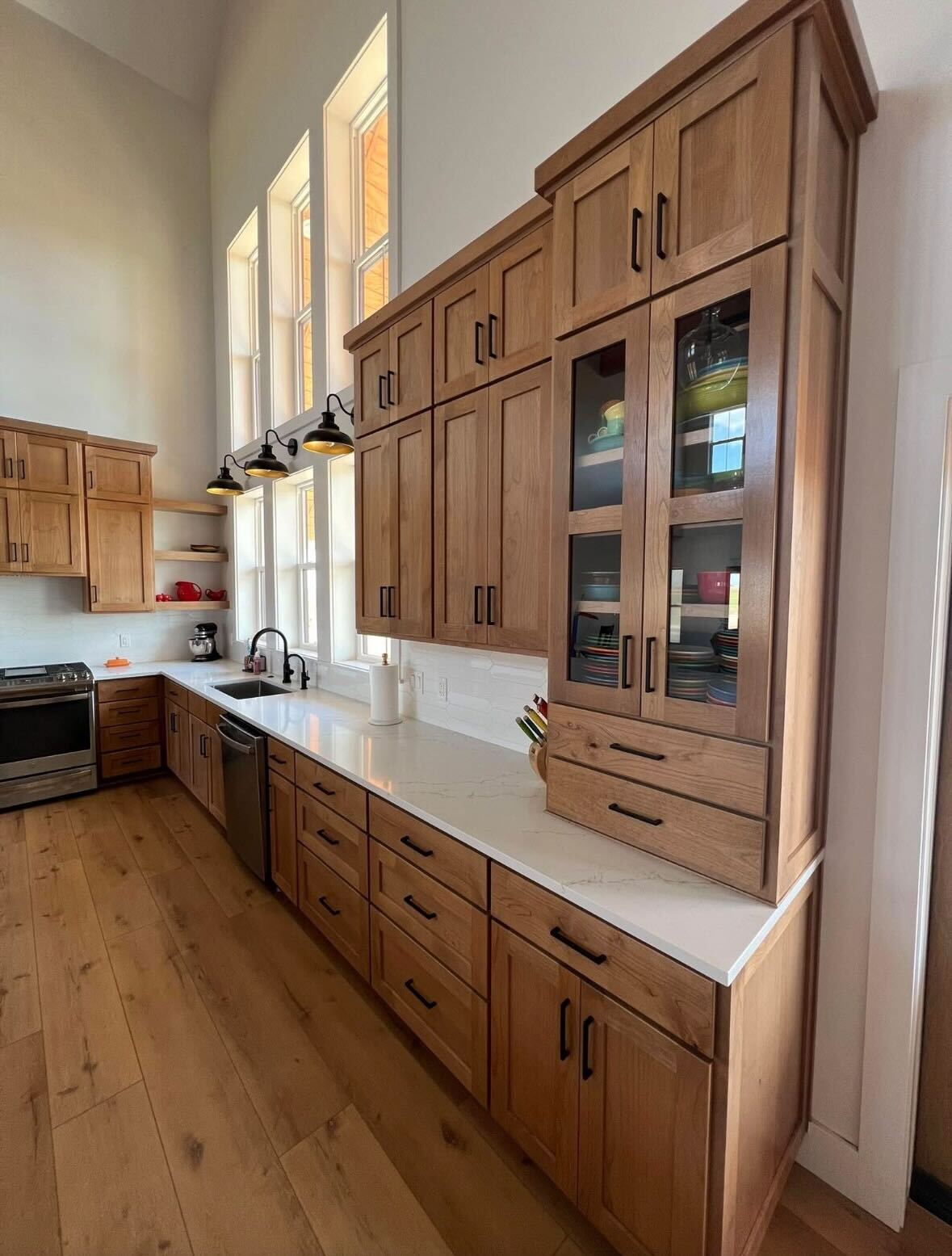 Natural oak kitchen cabinets with glass display doors