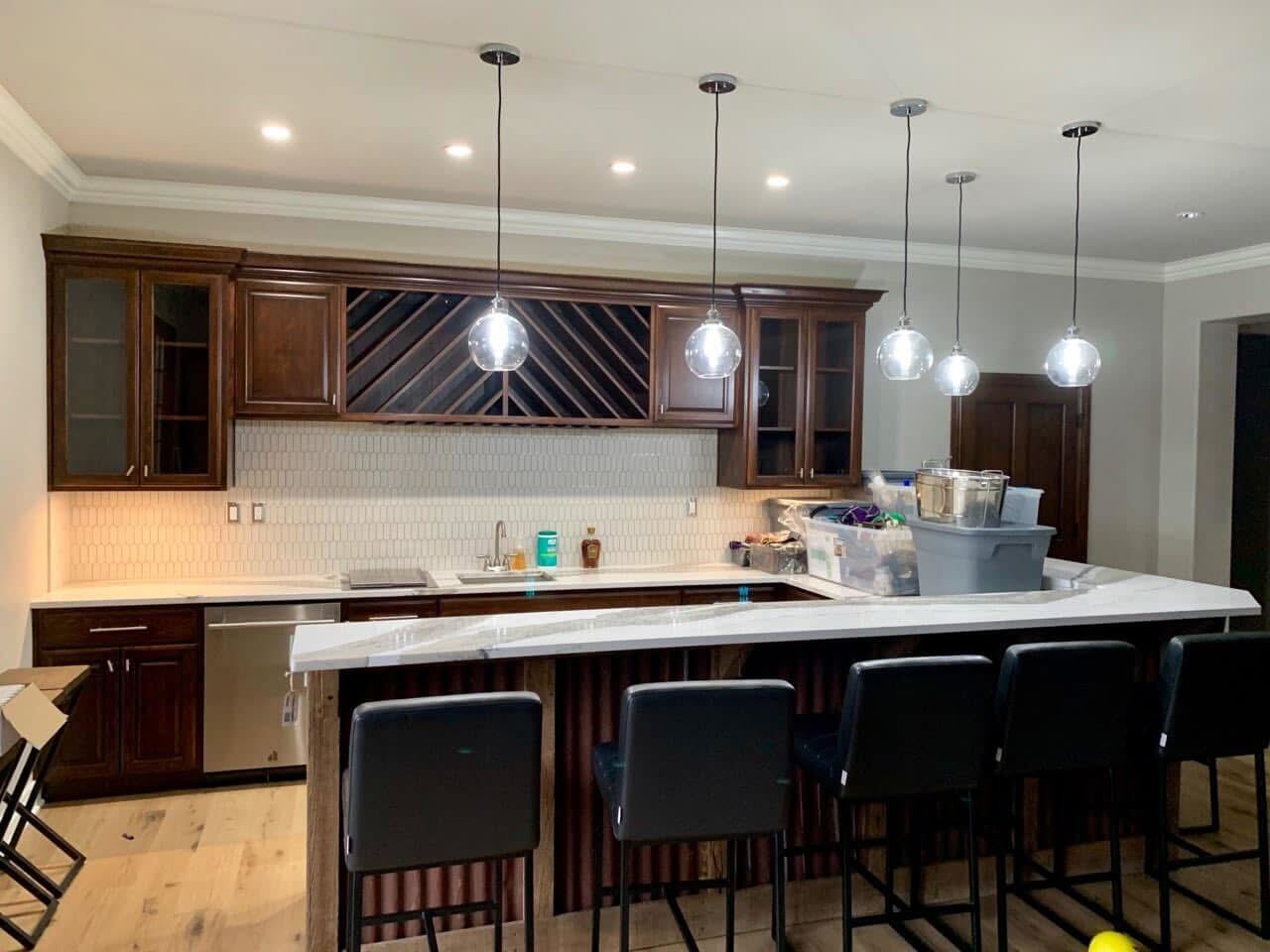 Dark walnut kitchen with wine rack and bar seating