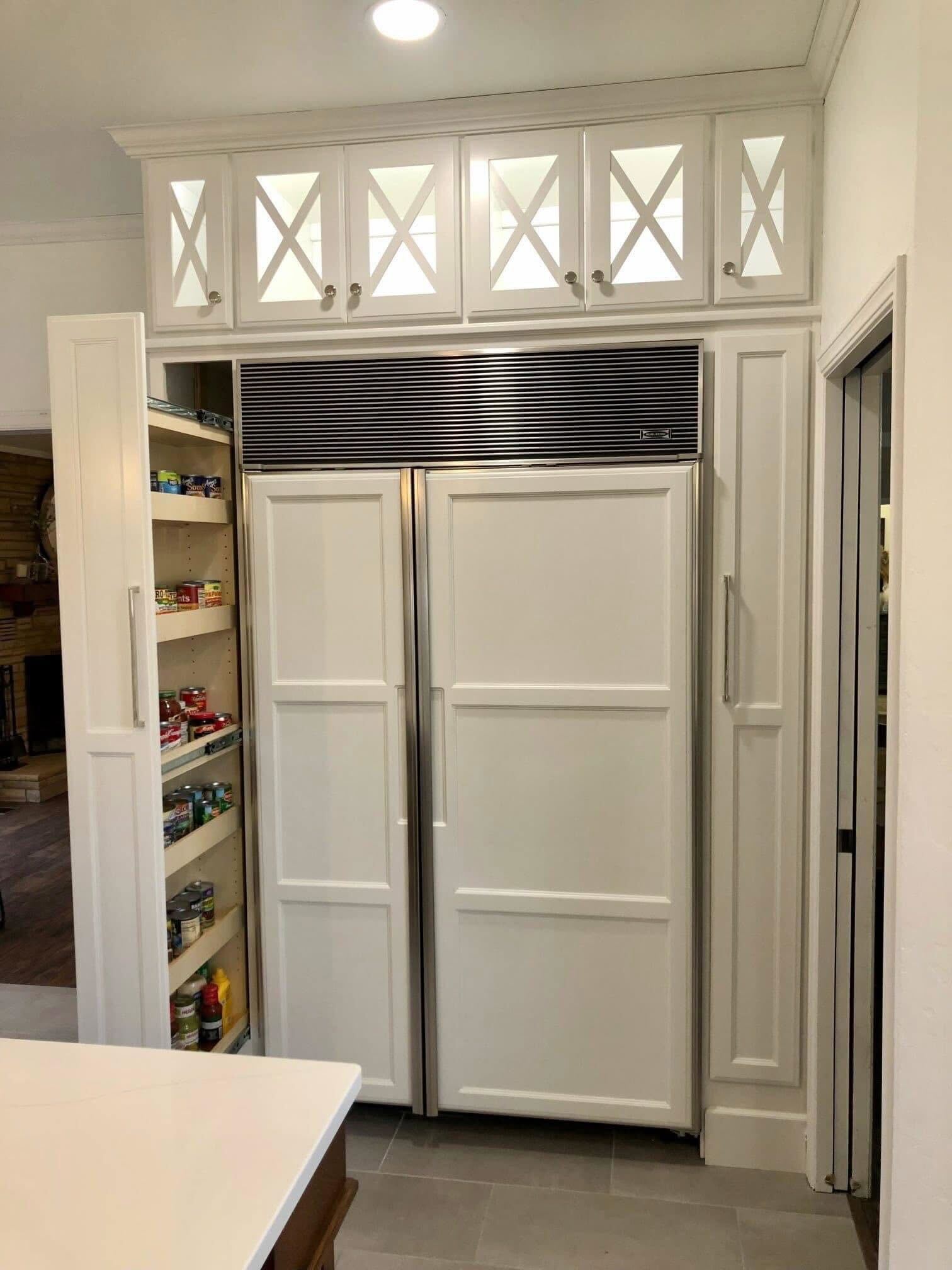 Floor-to-ceiling custom cabinetry with built-in pantry storage